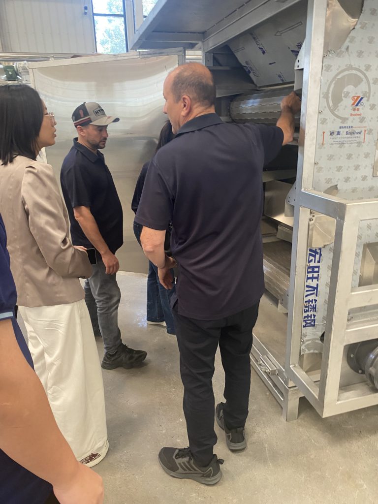 Australian visitors inspect a ZEKO industrial hot-air oven during a pet treat drying equipment visit